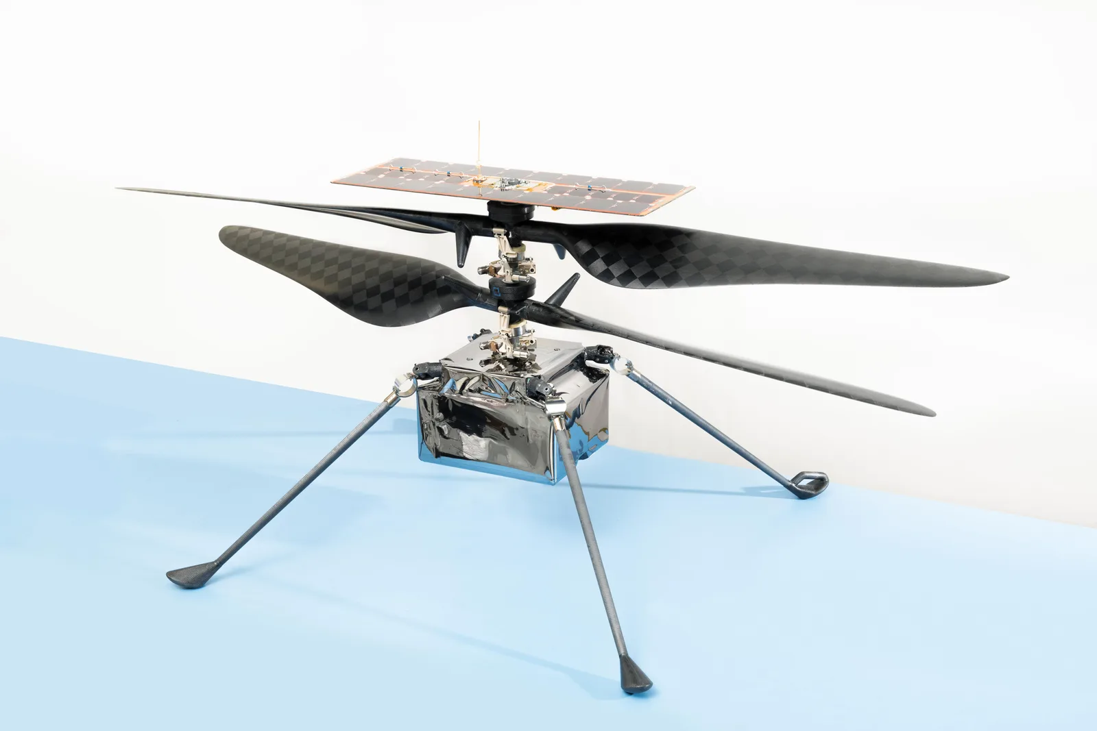 The flight model of the Ingenuity Mars Helicopter with its twin rotors and solar panel