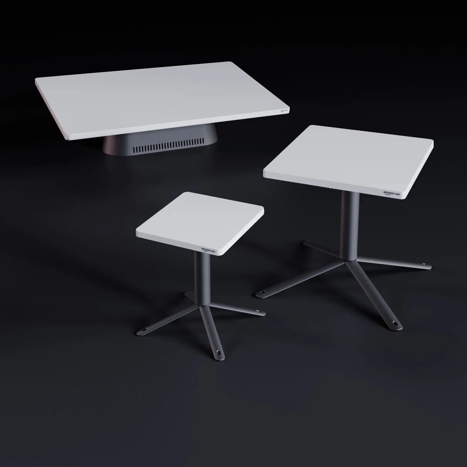 Three Amazon Leo customer terminals of different sizes, flat white antennas on stands