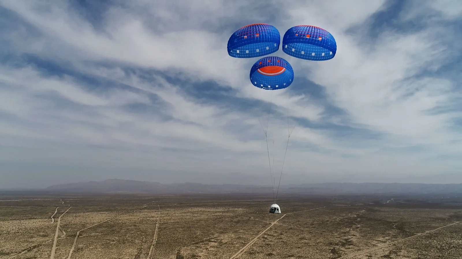 New Shepard crew capsule descending under three parachutes