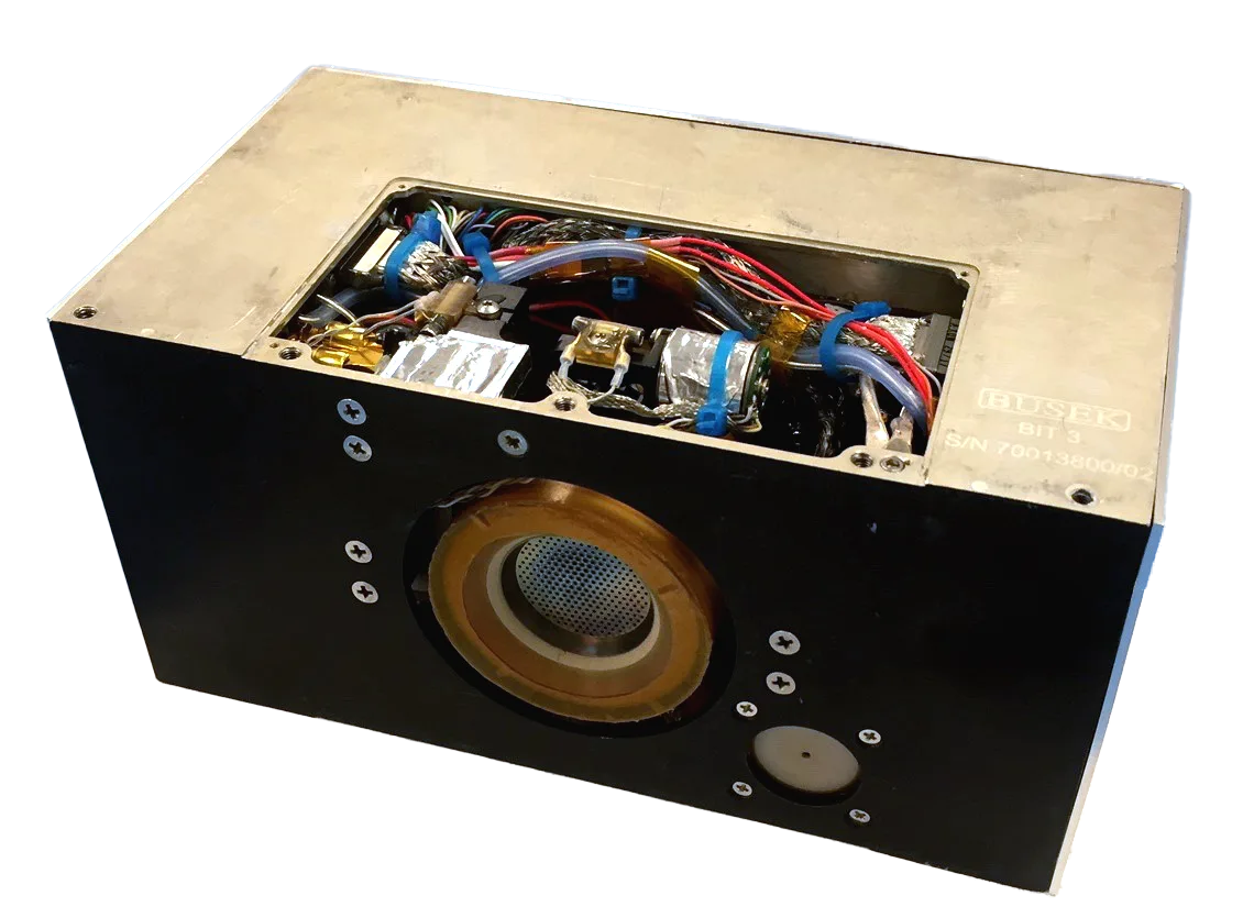 Busek BIT-3 RF ion thruster unit in its metal housing with the round ion grid on the front face and the electronics exposed on top