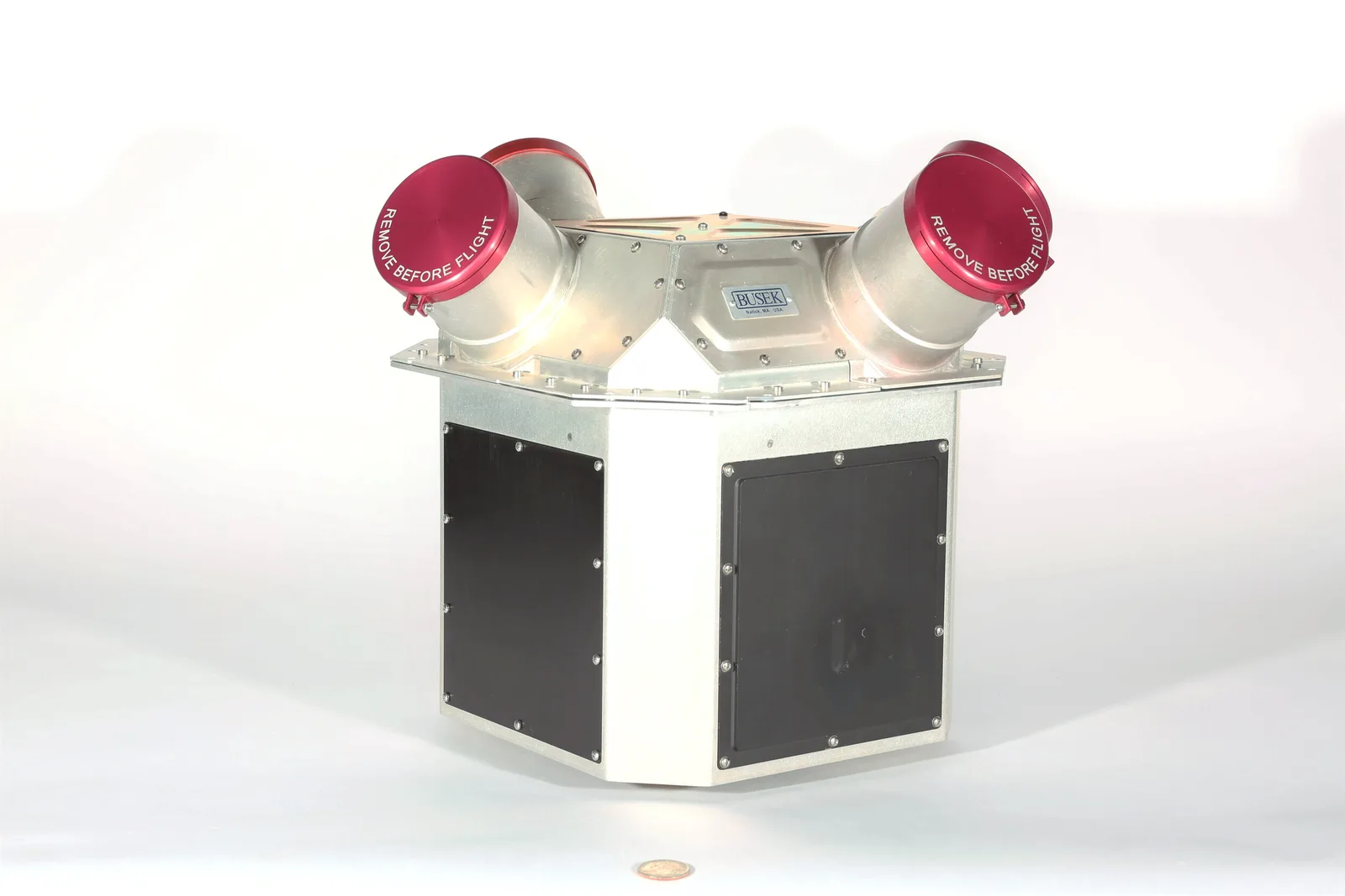 Busek electrospray thruster cluster with two red-capped thruster heads angled out from a white and black mounting body