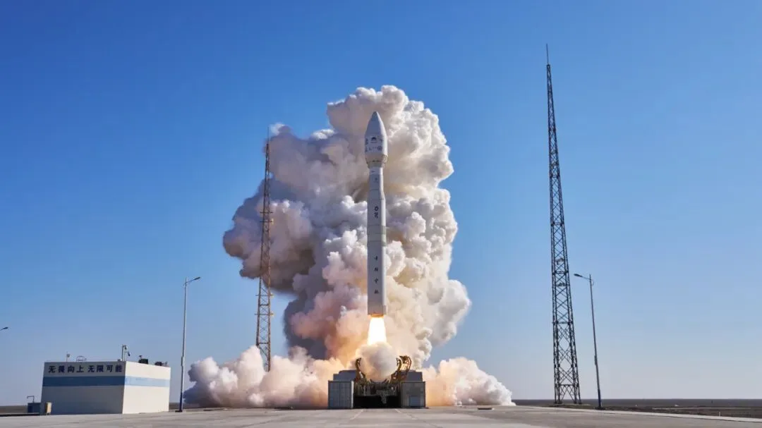 A Kinetica-1 solid-fuel rocket lifts off from its launch pad at the Jiuquan site under a clear blue sky