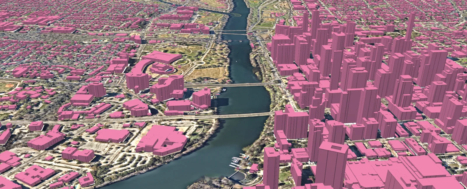 3D view of downtown Austin with buildings mapped as pink extruded shapes beside the river, from Ecopia land cover data