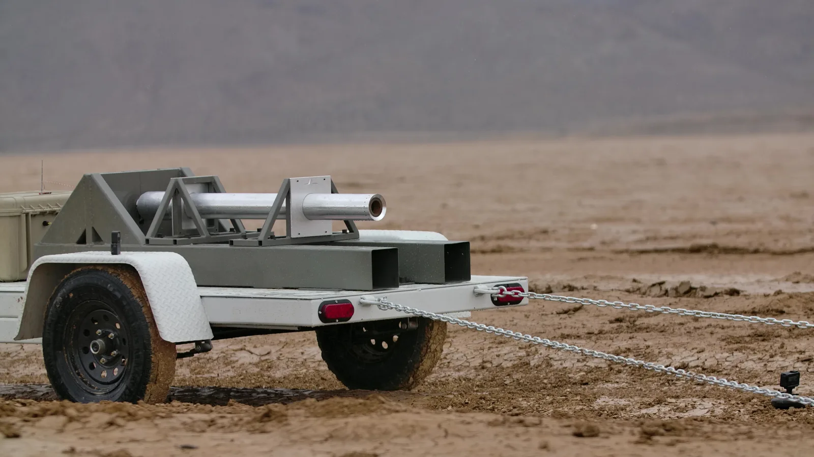 Evolution Space solid rocket motor mounted on a mobile test trailer on a dry lakebed, chained down for a static fire
