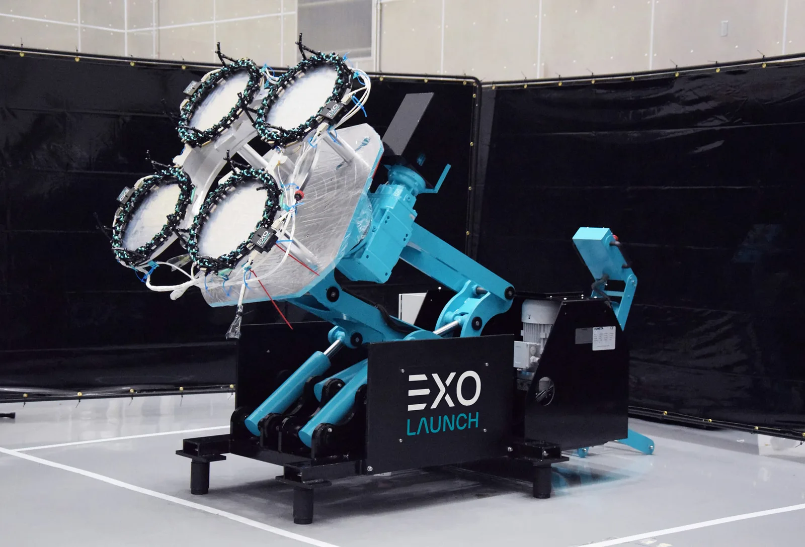 Exolaunch engineers in a cleanroom beside small satellites mounted on separation hardware for integration