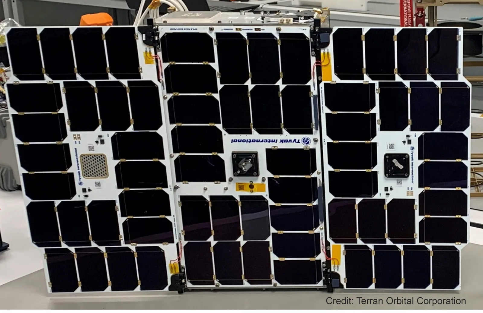 CICERO-2 satellite with its black solar panels unfolded in a cleanroom before launch