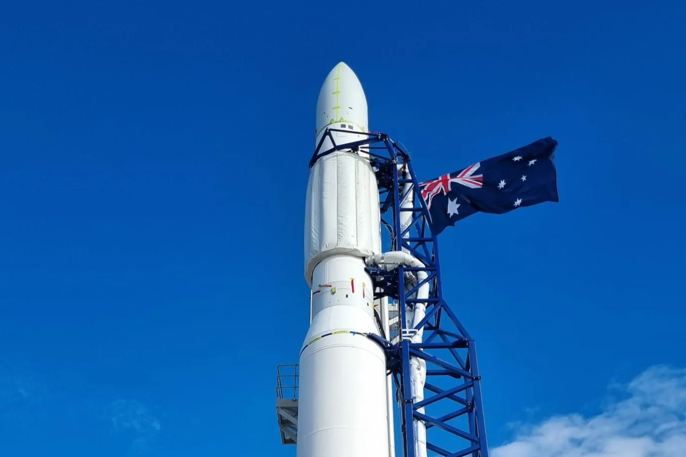 Gilmour Space's Eris rocket on its launch tower at Bowen Orbital Spaceport with the Australian flag