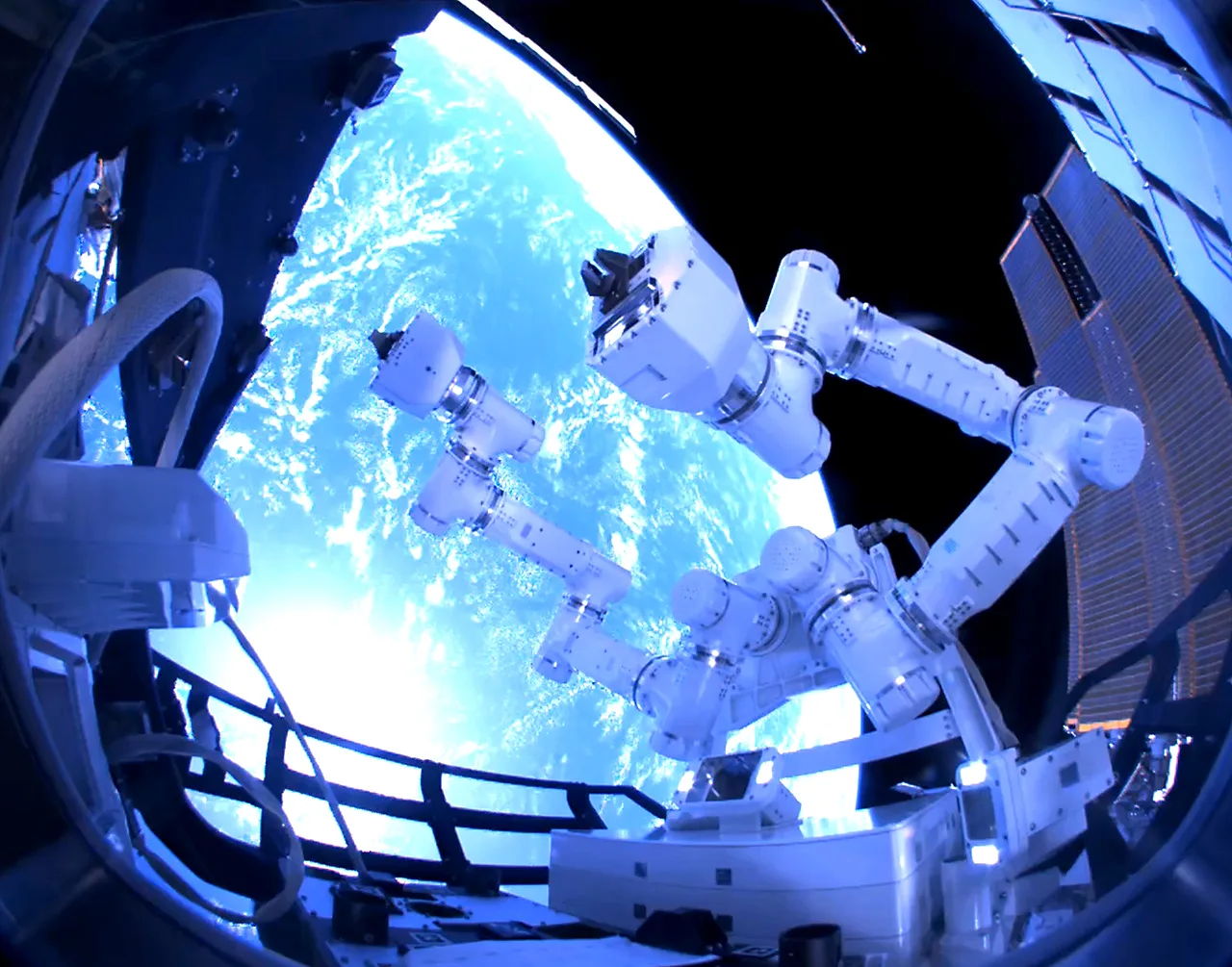 GITAI S2 dual robotic arms working outside the International Space Station with Earth behind