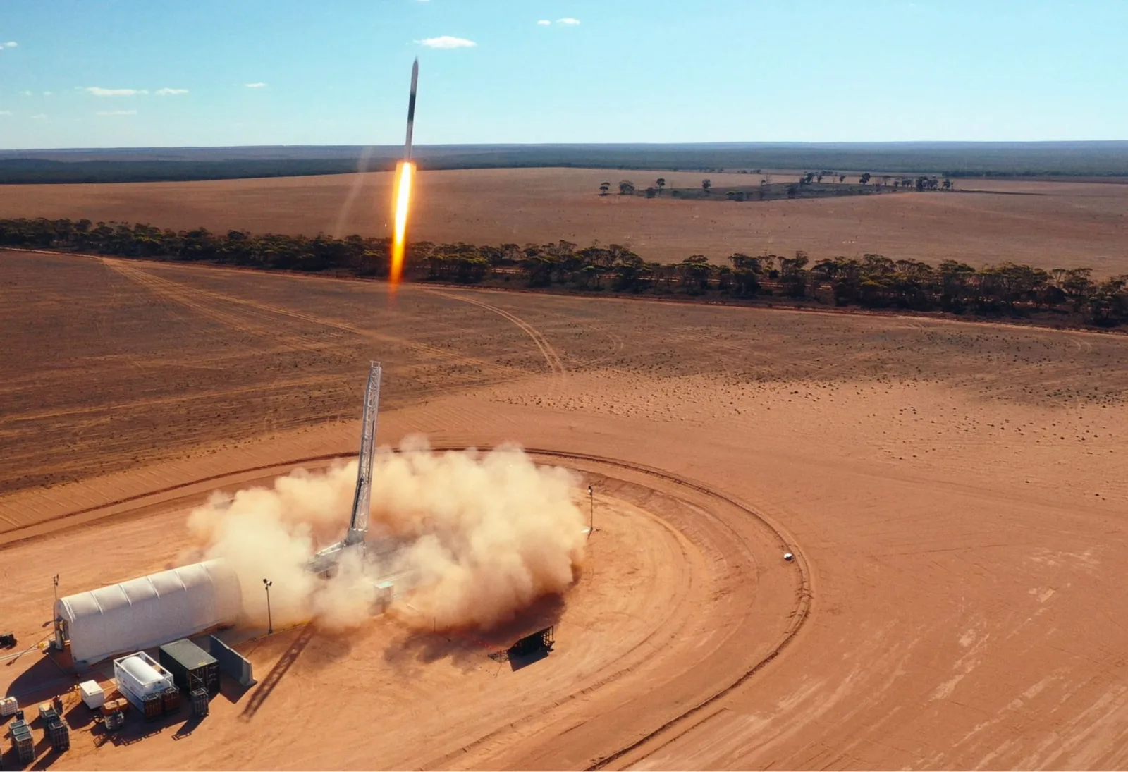 Aerial view of the HyImpulse SR75 hybrid rocket lifting off from its launch site in South Australia