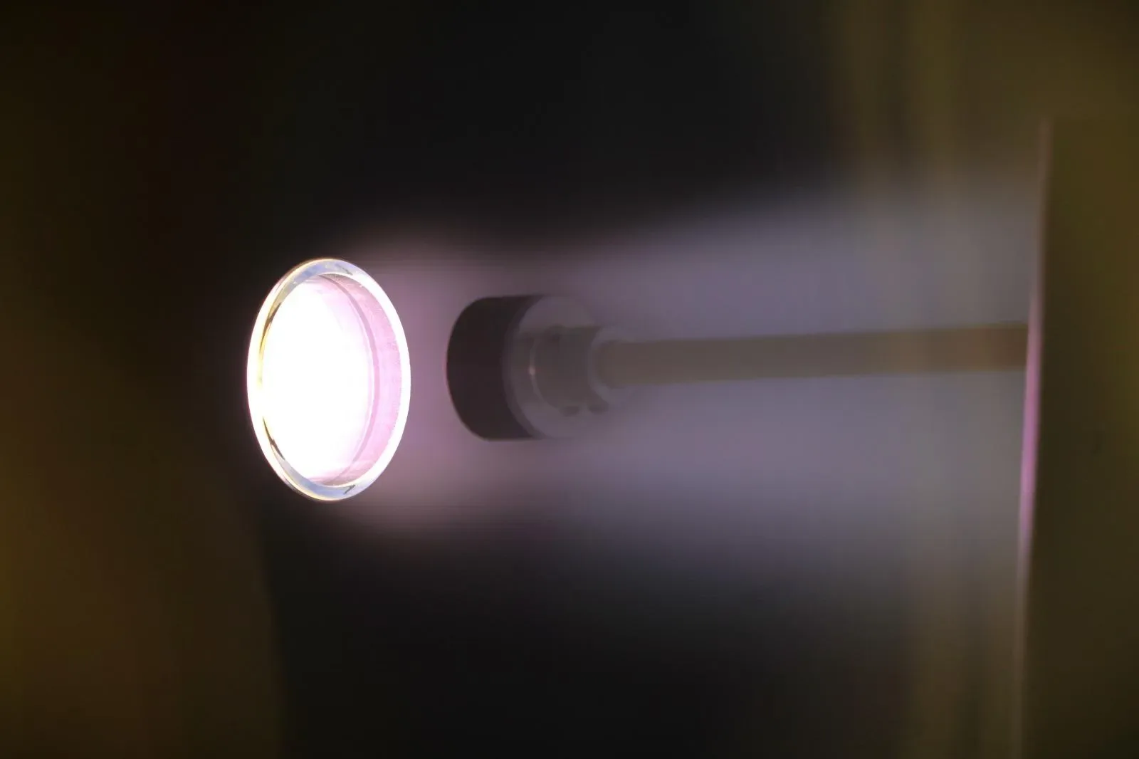 Kreios Space air-breathing electric thruster glowing during a firing test in a vacuum chamber
