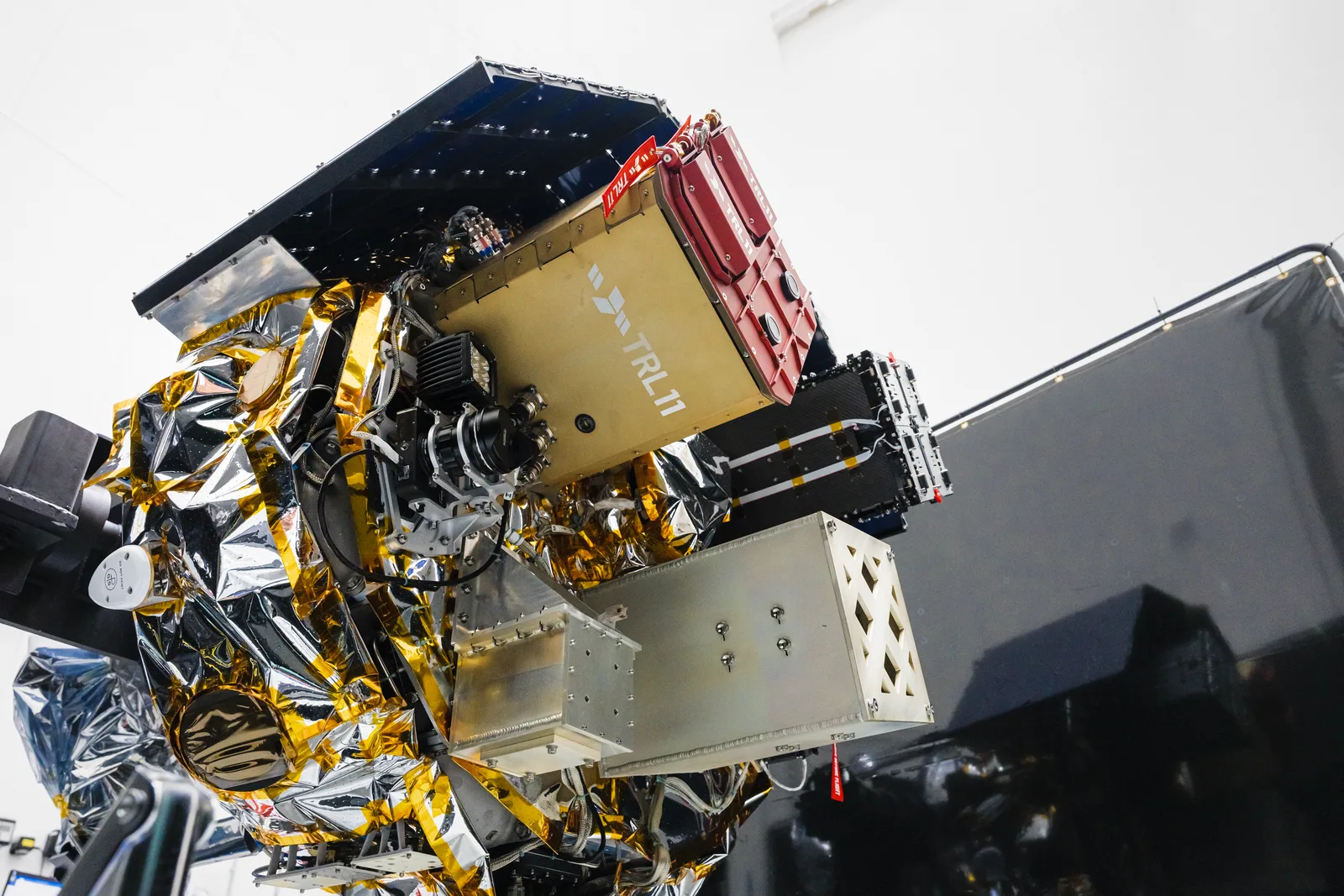 Launcher Orbiter SN1 space tug with mounted payloads in a payload processing facility before launch