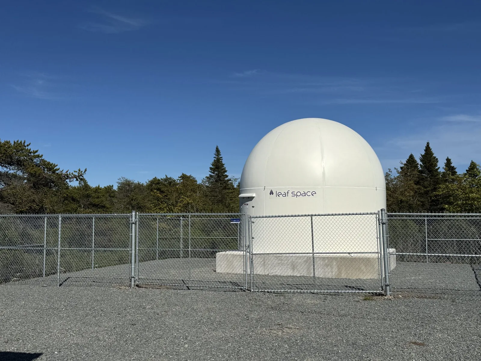 Leaf Space ground station radome inside a fenced compound at Spaceport Nova Scotia