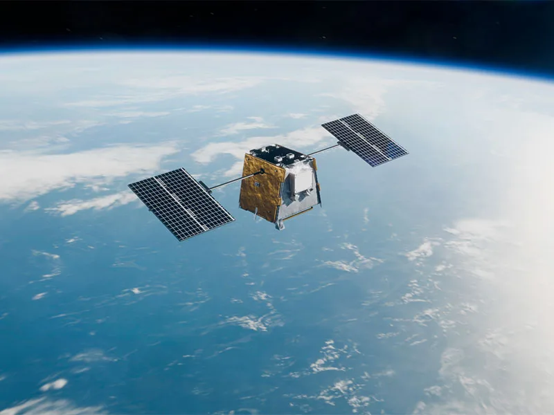 Render of a Loft Orbital Longbow satellite with two solar arrays orbiting above Earth