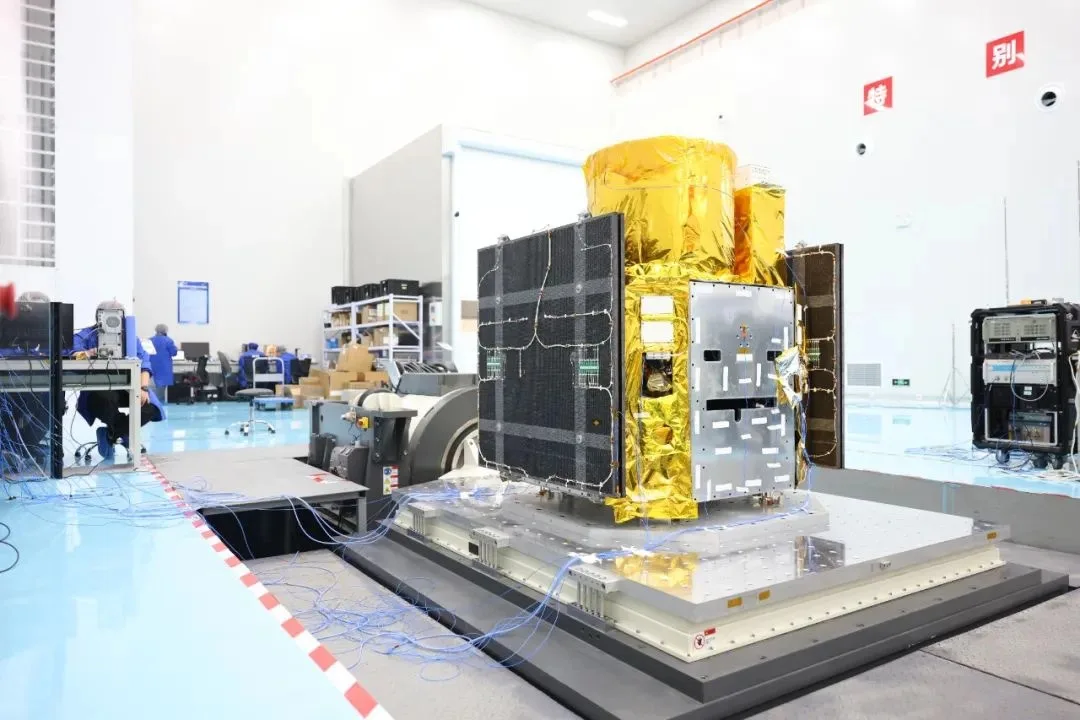 MinoSpace satellite with gold thermal blanket and solar panels on an integration stand in a cleanroom