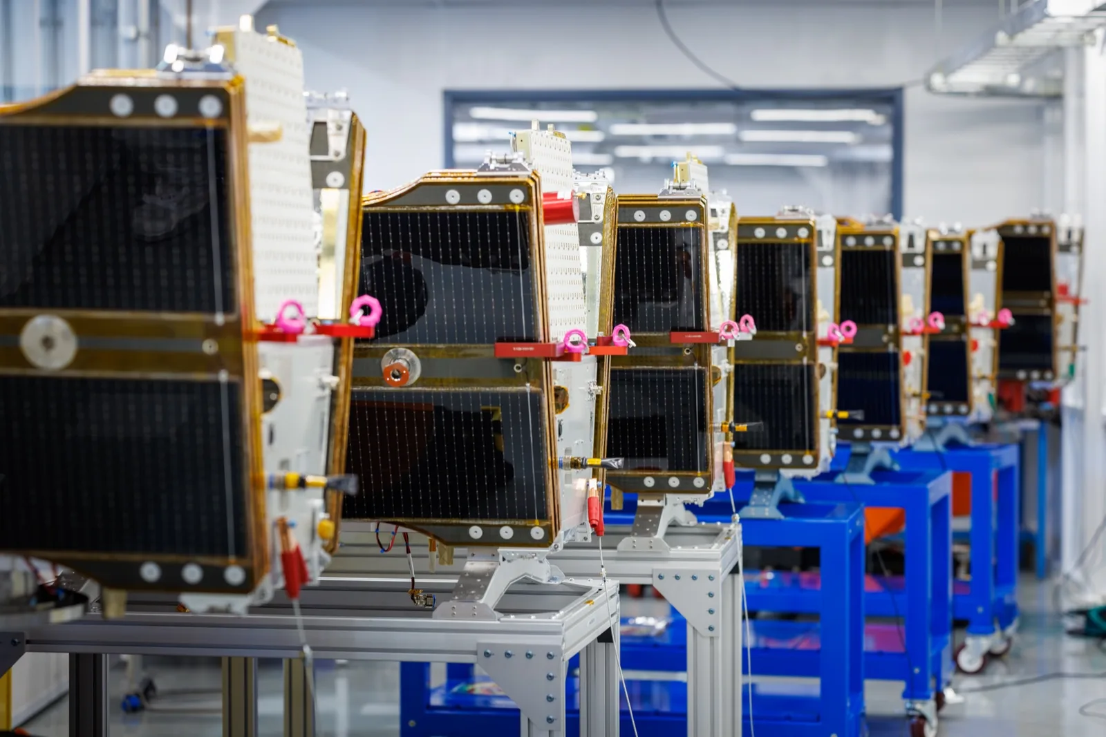 Row of Muon Space satellites on the production floor at the company's factory
