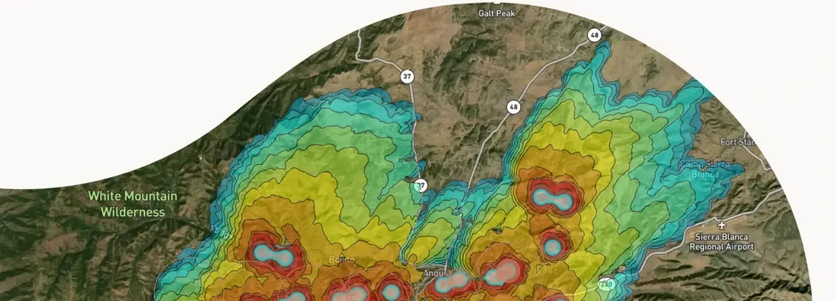 OroraTech Wildfire Solution screenshot showing a color-coded fire spread forecast over satellite imagery near the White Mountain Wilderness