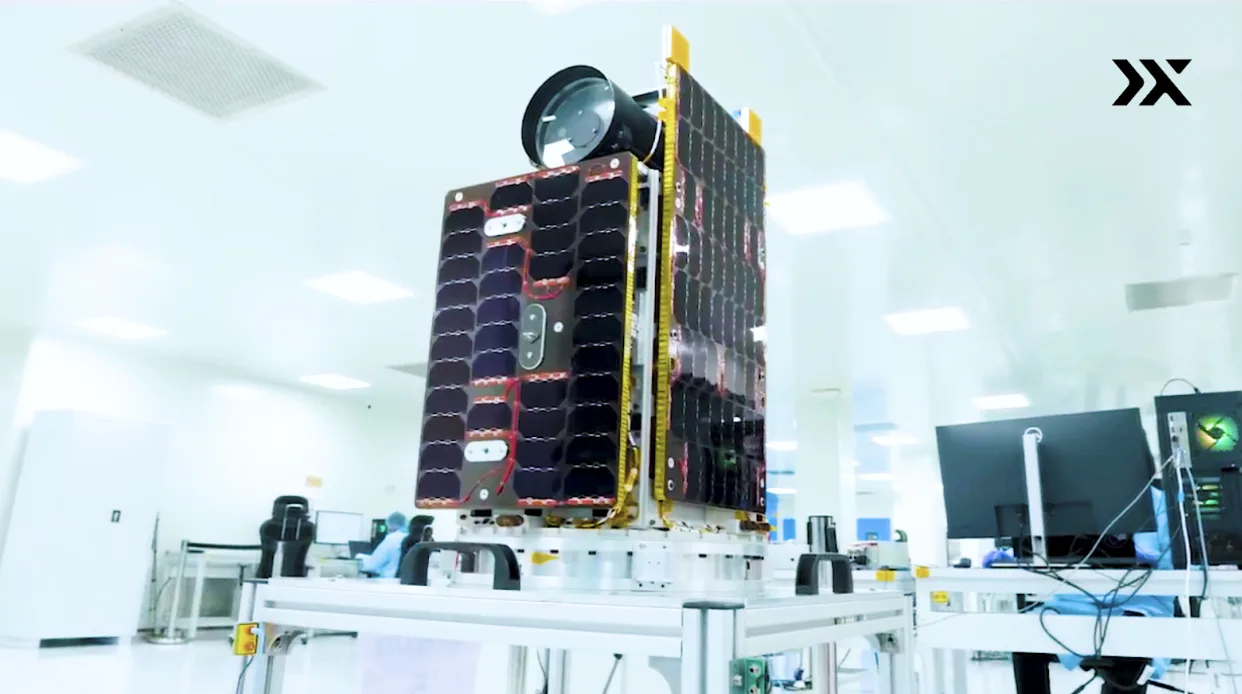 A Pixxel Firefly hyperspectral imaging satellite on a stand in a clean room
