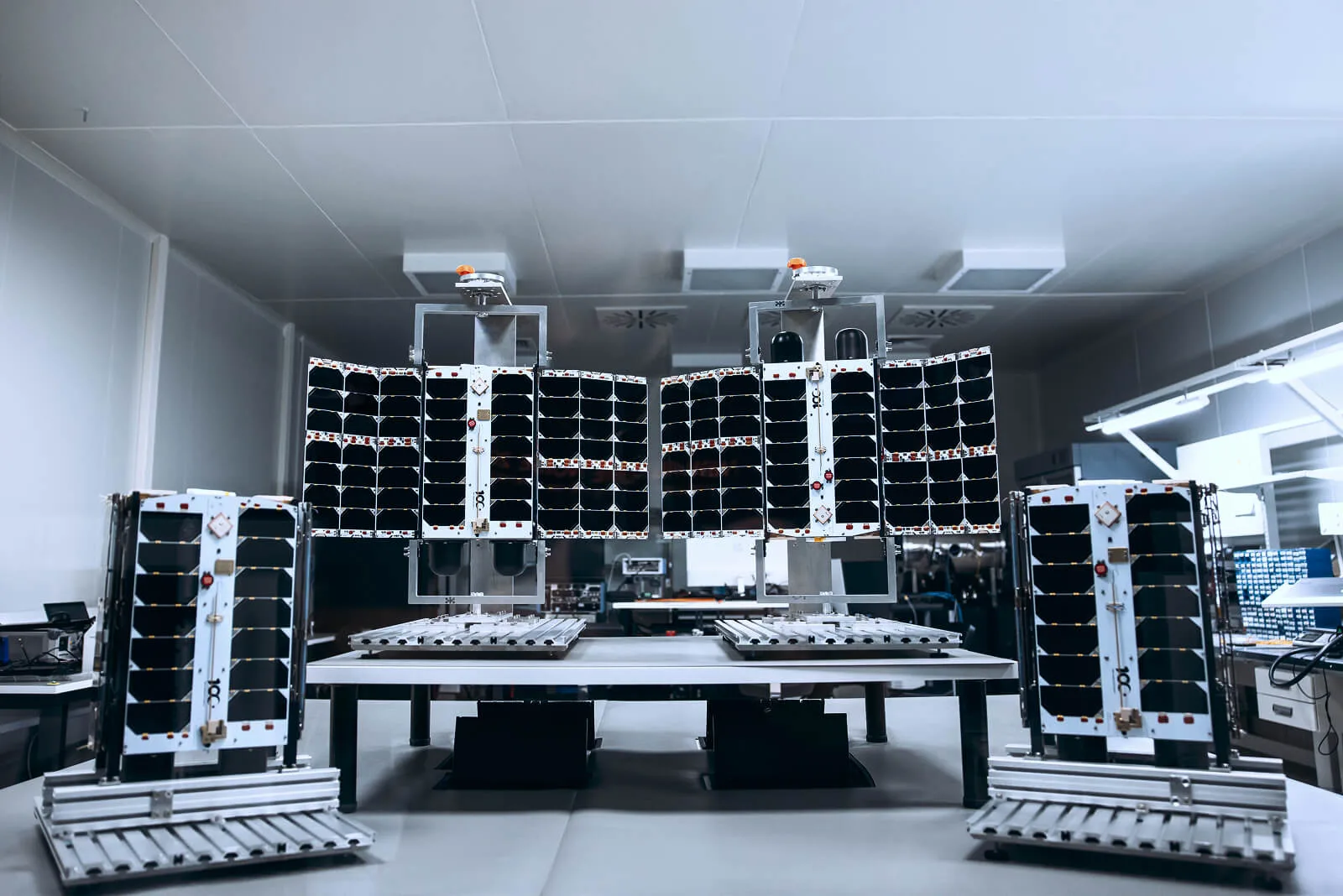 Four Plan-S Connecta IoT satellites lined up in a clean room before launch