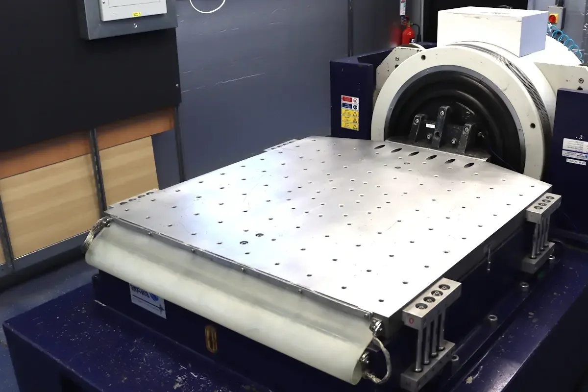 A large electrodynamic vibration test table with a flat slip plate in Resonate Testing's lab