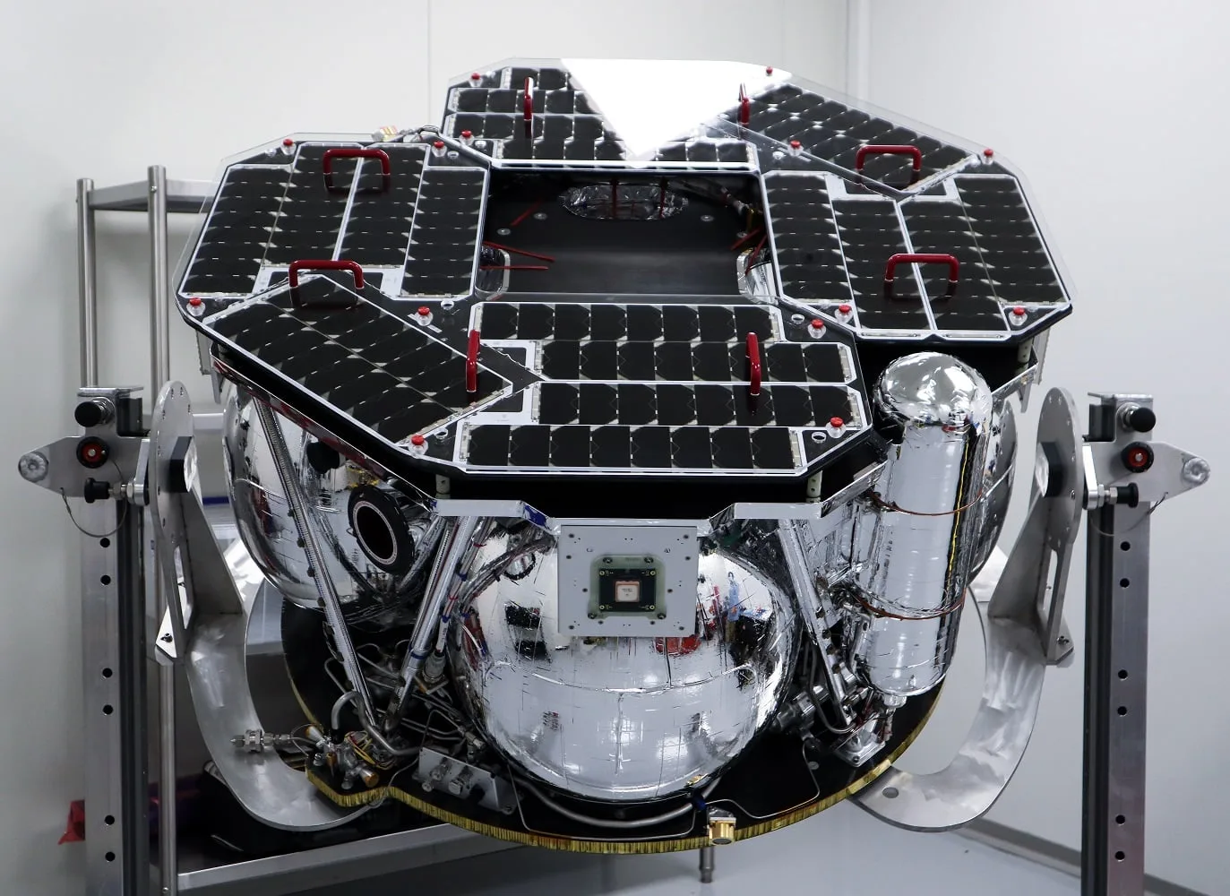 Rocket Lab's Photon-based CAPSTONE spacecraft with its solar panels, mounted on a stand in a clean room