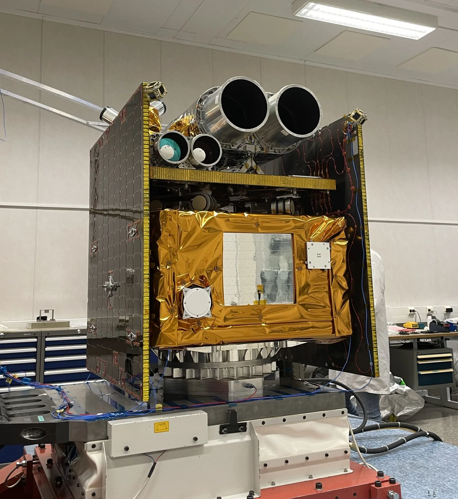 The GARAI A satellite in a clean room, with its iSIM camera pair mounted on top and gold thermal blanketing on the body