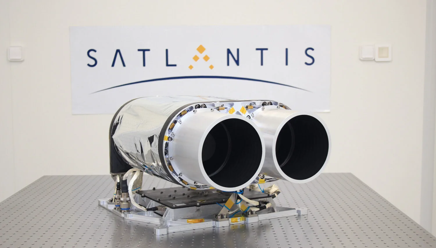SATLANTIS iSIM-170 binocular space camera with two silver telescope barrels on a lab optical bench
