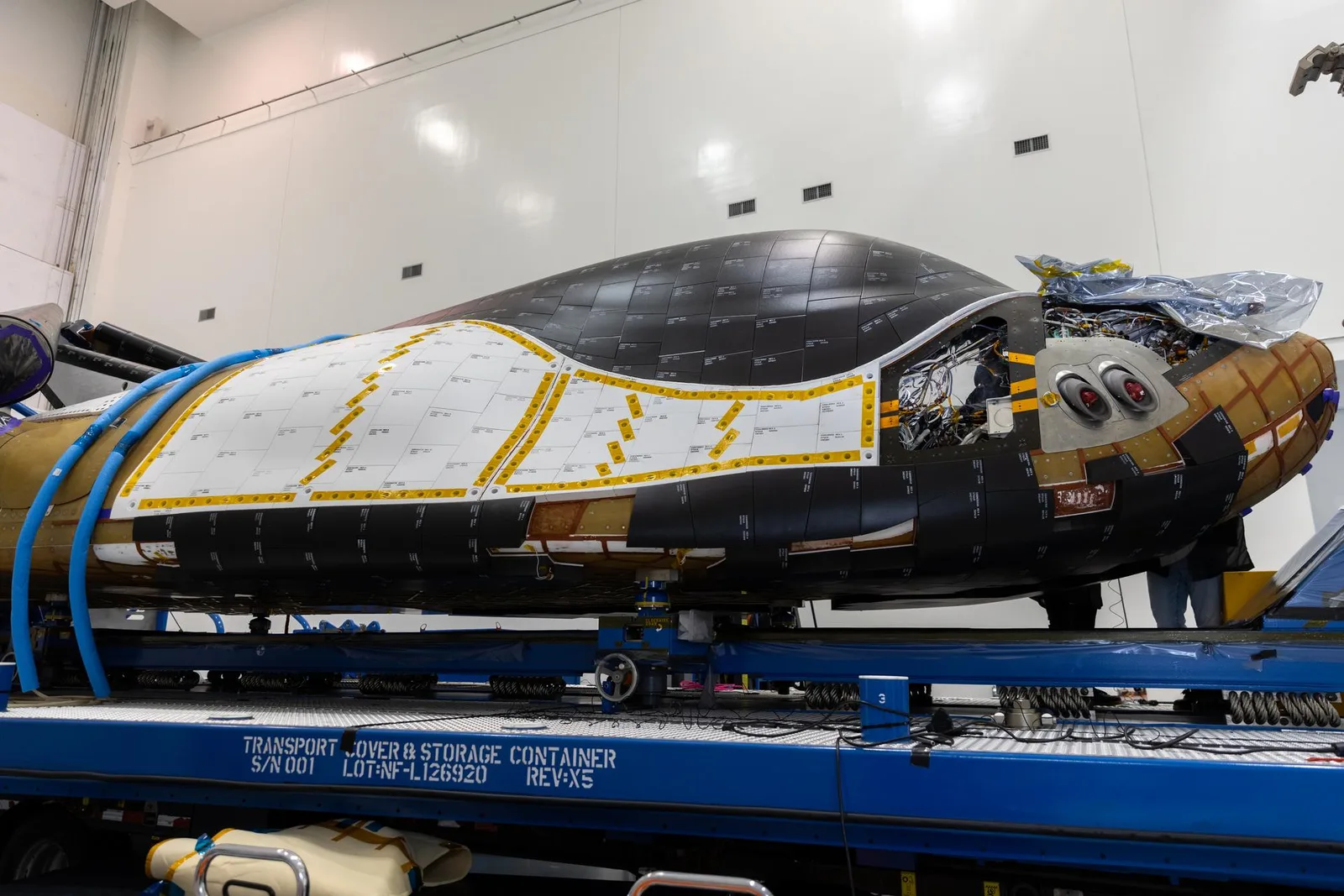 Dream Chaser Tenacity spaceplane on its transport stand inside a processing facility at Kennedy Space Center