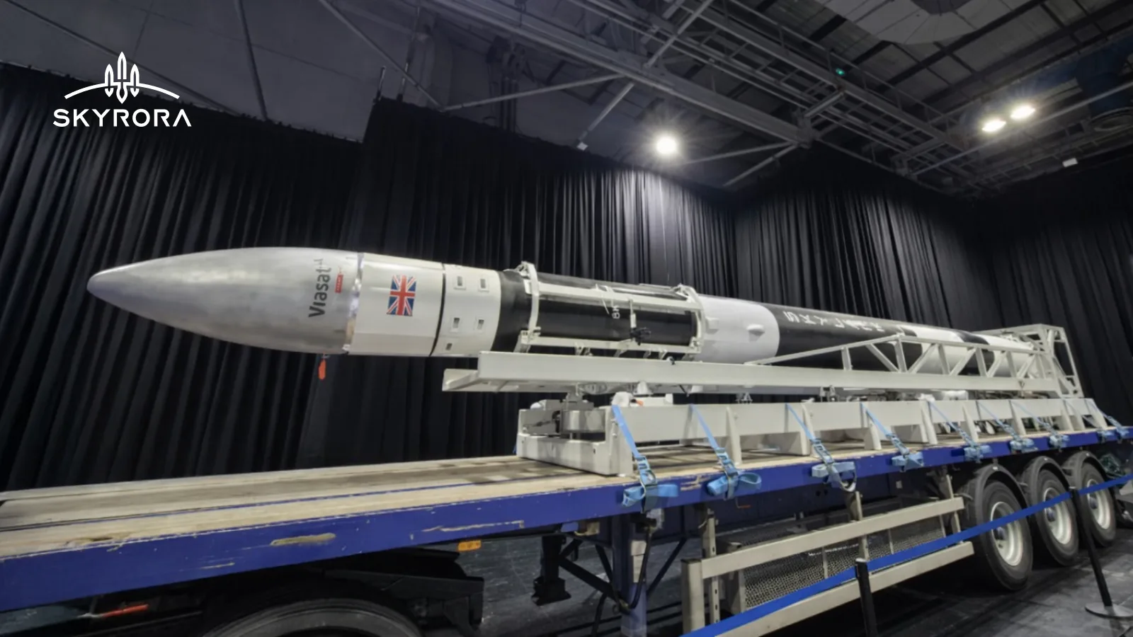 The Skylark L suborbital rocket lying horizontally on its transporter-erector trailer inside an exhibition hall