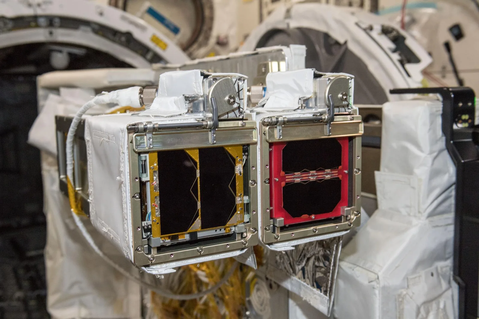 JEM Small Satellite Orbital Deployers mounted on the Kibo module's experiment platform aboard the ISS