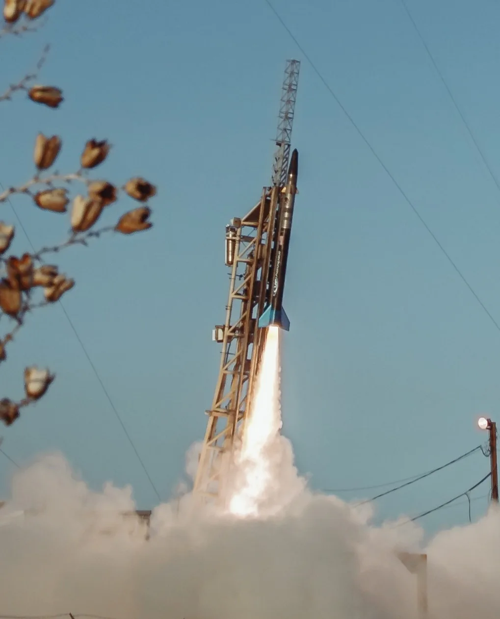 A UP Aerospace Spyder sounding rocket lifting off from its launch rail in a cloud of exhaust