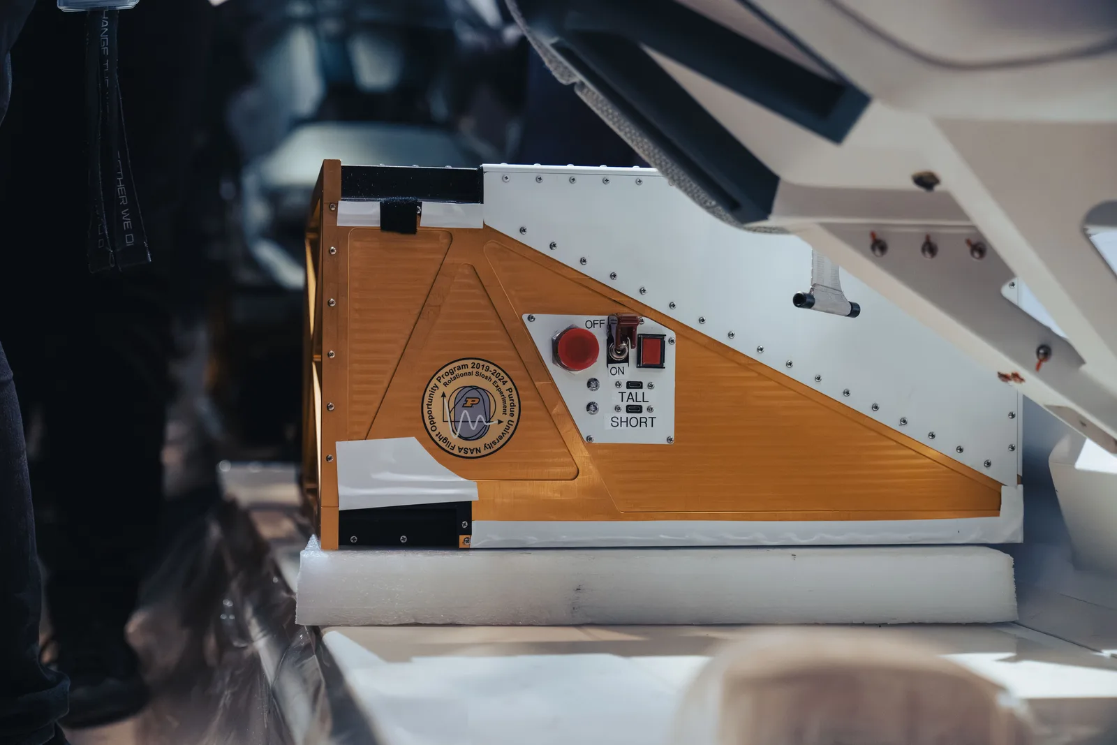 A research payload rack mounted inside the passenger cabin of a Virgin Galactic spaceship